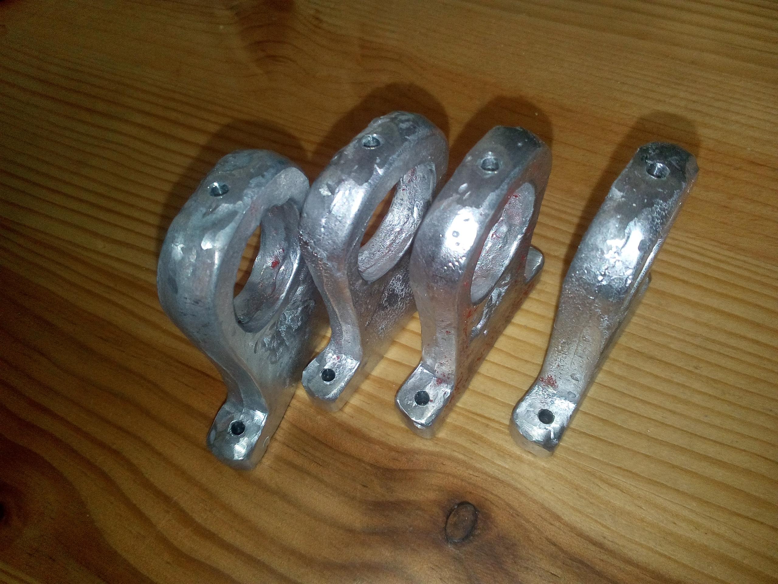 The four gimbal pieces, once polished and drilled.